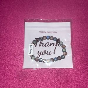 This is a space bracelet, on the stone it says believe, it  stretches out .